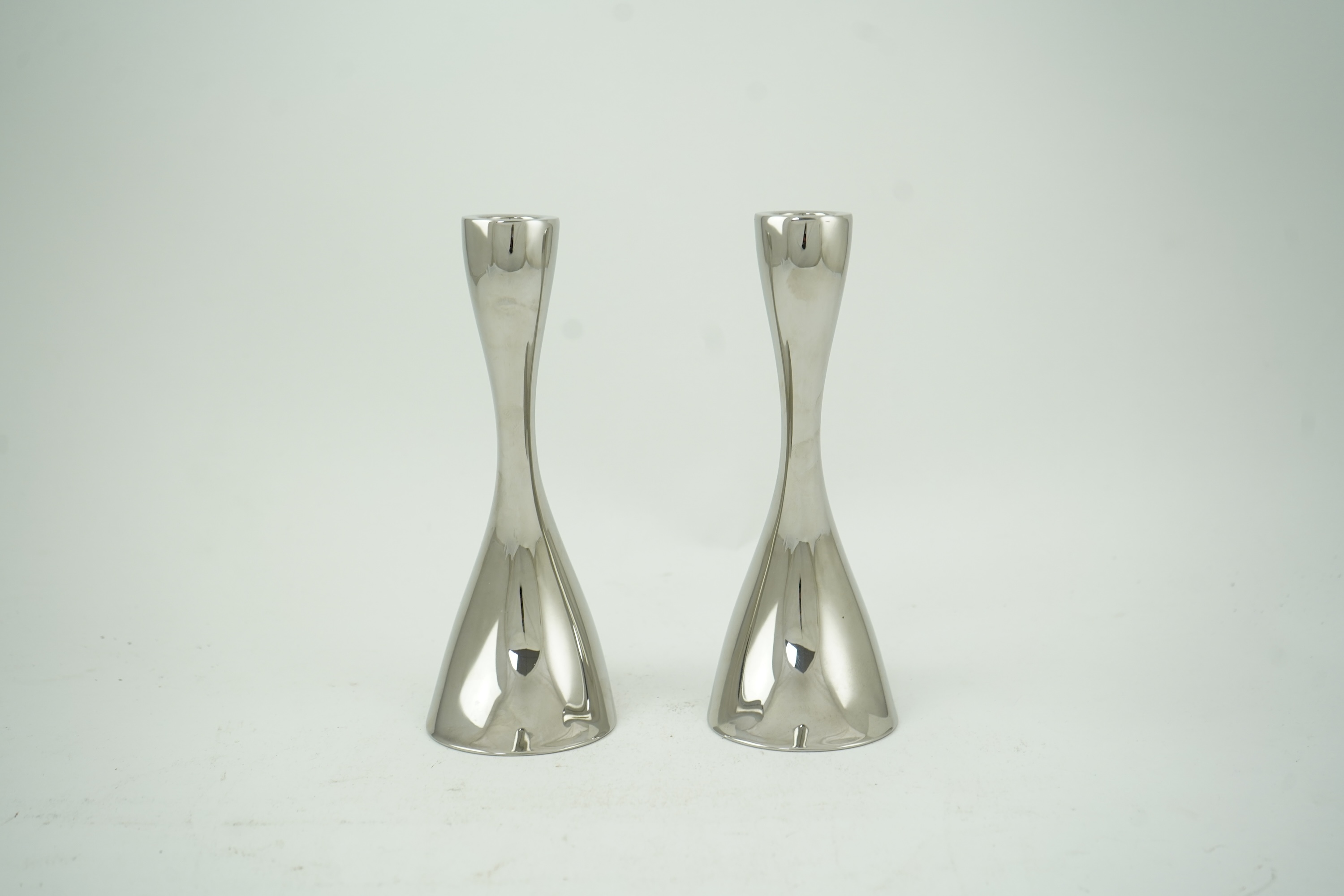 Constantin Wortmann for Georg Jensen: A pair 'of Cobra' polished steel candlesticks, marked 